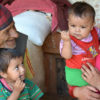 A Nepali mother with two young boys and their grandfather.